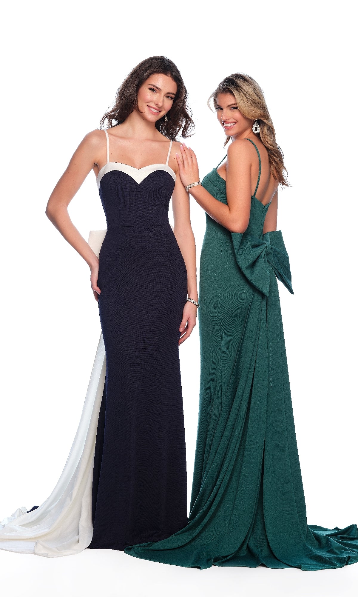 Two women pose in formal gowns—one wears a form-fitting black and white prom dress with spaghetti straps, while the other stands out in the Dave & Johnny 11410 long prom dress in emerald green, featuring a statement bow and thin straps.